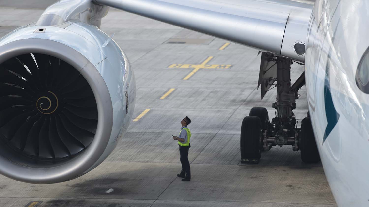 Man inspecting aircraft engine